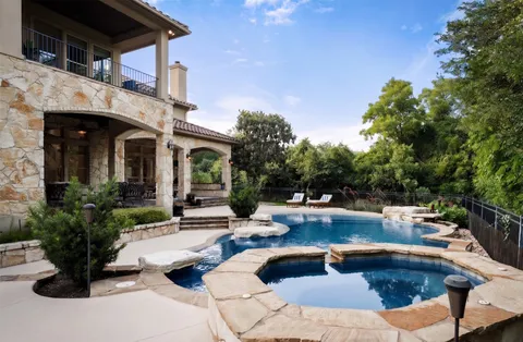 a view of a house with swimming pool and sitting area