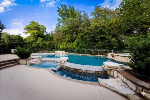 a view of a roof deck with couches and wooden fence