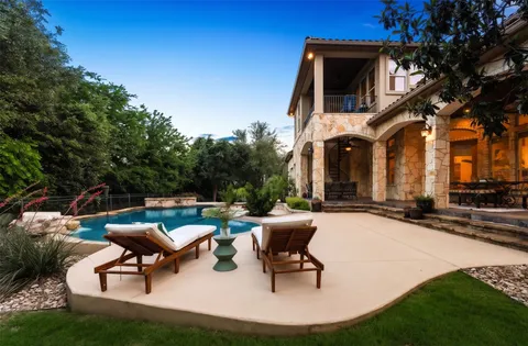 a building outdoor space with patio furniture and potted plants