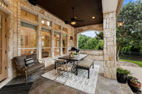 a building outdoor space with patio furniture and potted plants