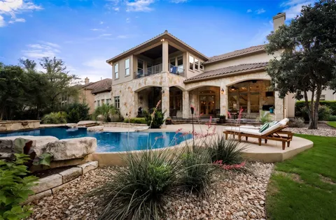 a view of a building with a fountain and a fire pit