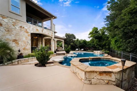 a view of a patio with swimming pool table and chairs