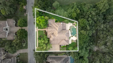 an aerial view of a house with a yard