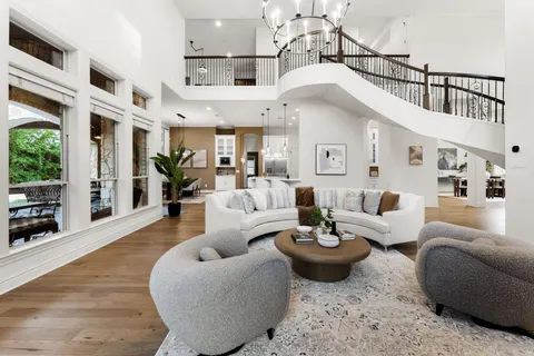 a living room with furniture a rug and a view of kitchen