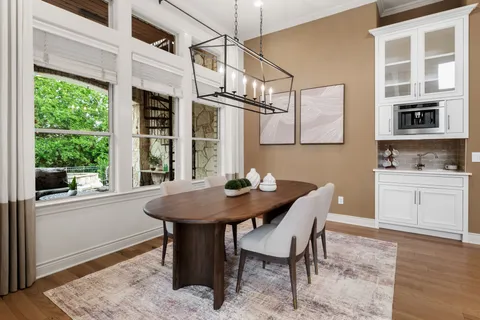 a view of a kitchen with a table and chairs