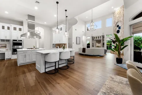 a large kitchen with a table and chairs