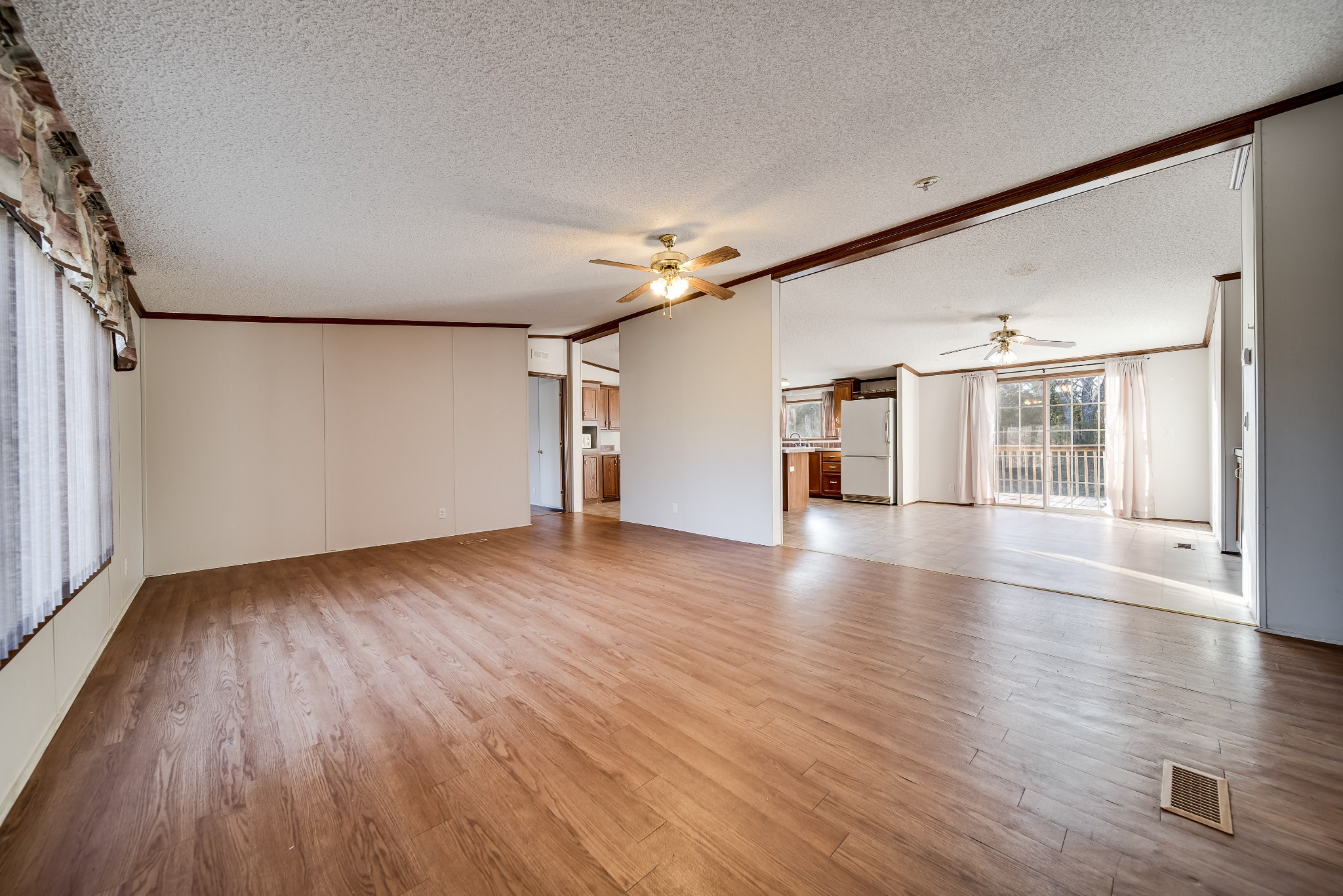7363 Deer Ridge Road Fairview, TN 37062 - Photo 12 of 24 an empty room with wooden floor chandelier and windows