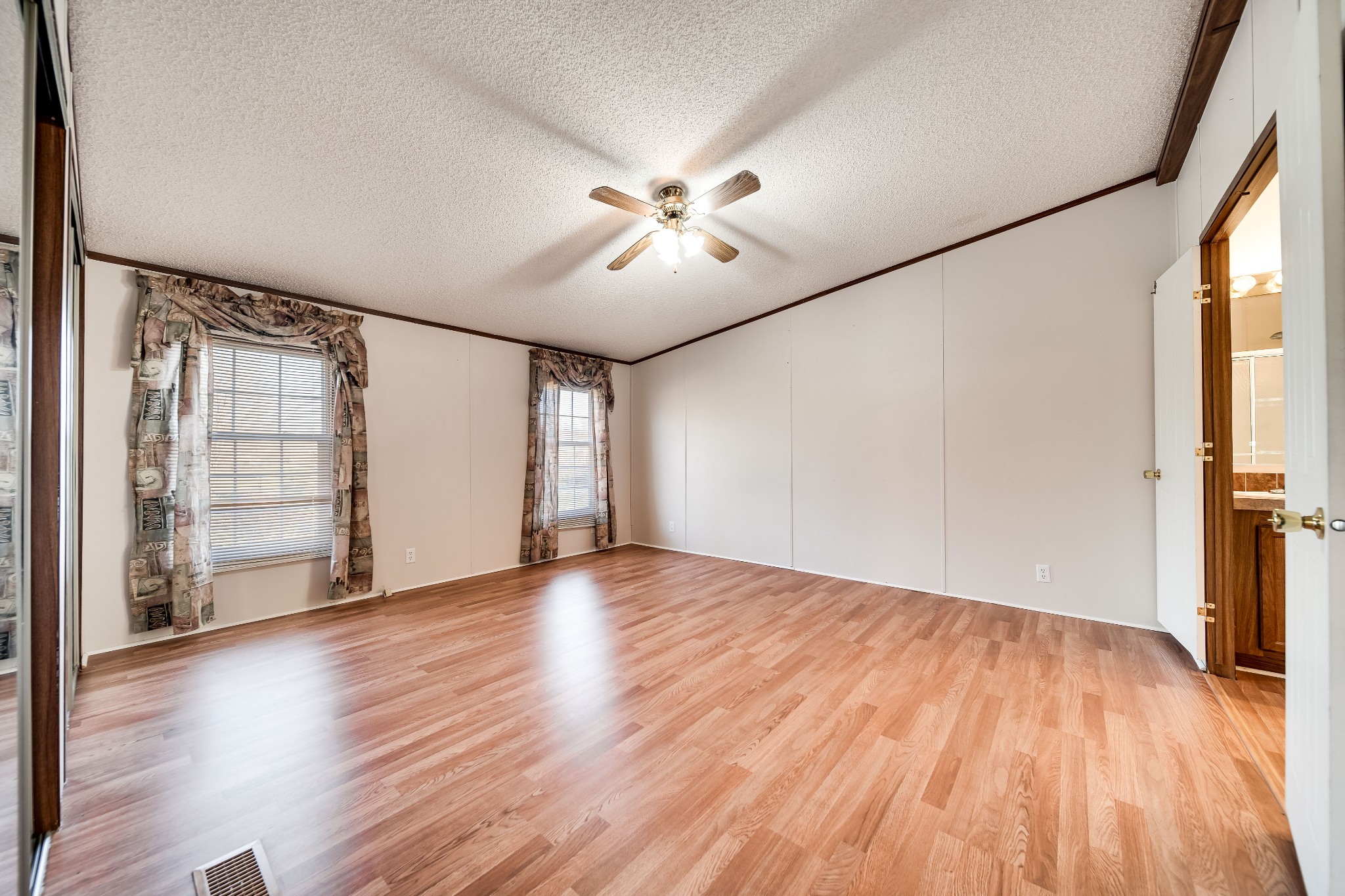 7363 Deer Ridge Road Fairview, TN 37062 - Photo 16 of 24 an empty room with wooden floor chandelier fan and windows