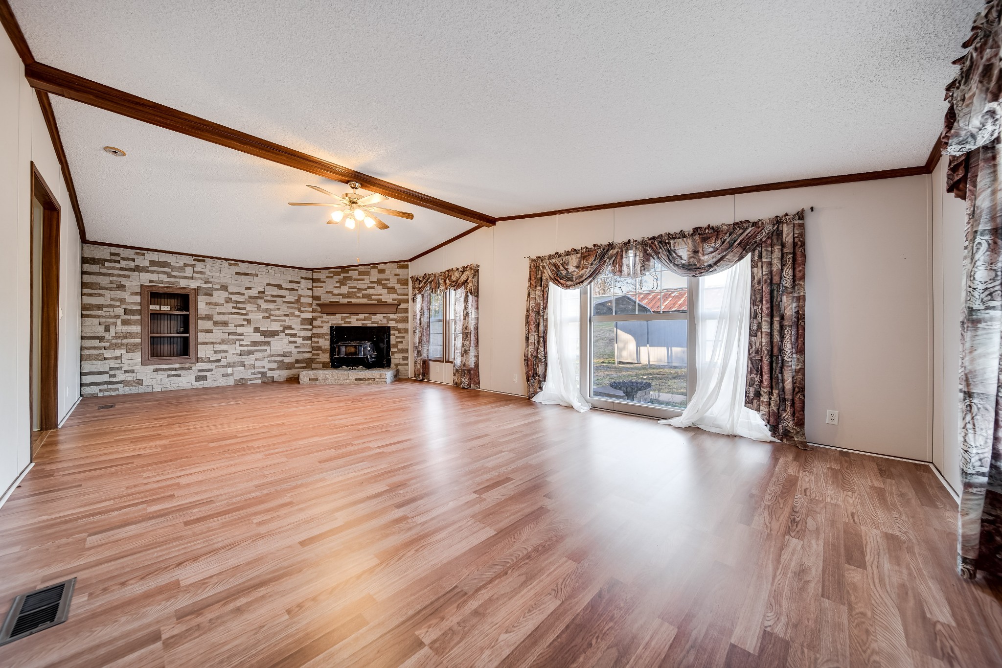 7363 Deer Ridge Road Fairview, TN 37062 - Photo 3 of 24 a view of a livingroom with wooden floor and a fireplace