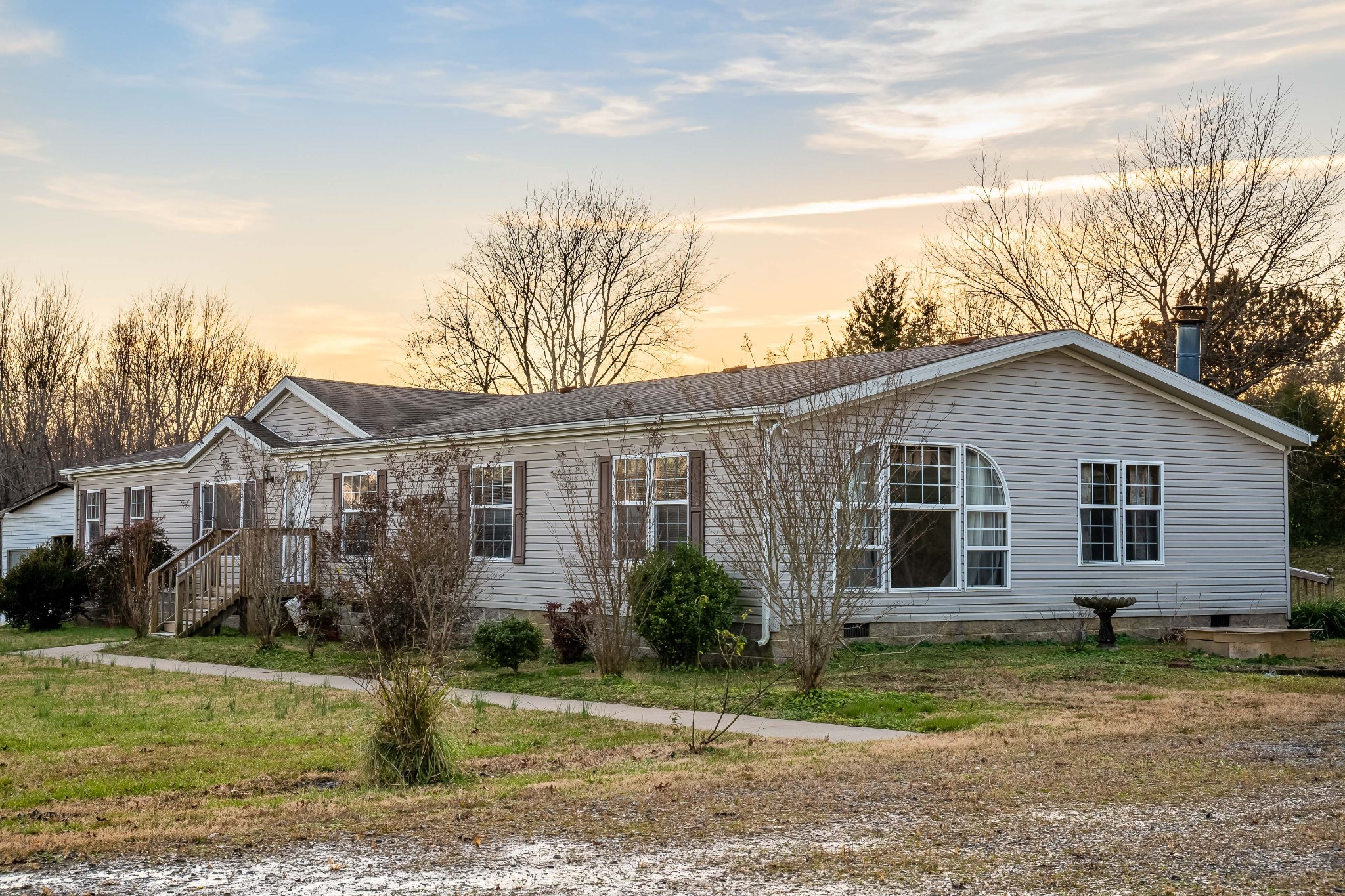 7363 Deer Ridge Road Fairview, TN 37062 - Photo 4 of 24 a view of a yard in front of a house with large windows