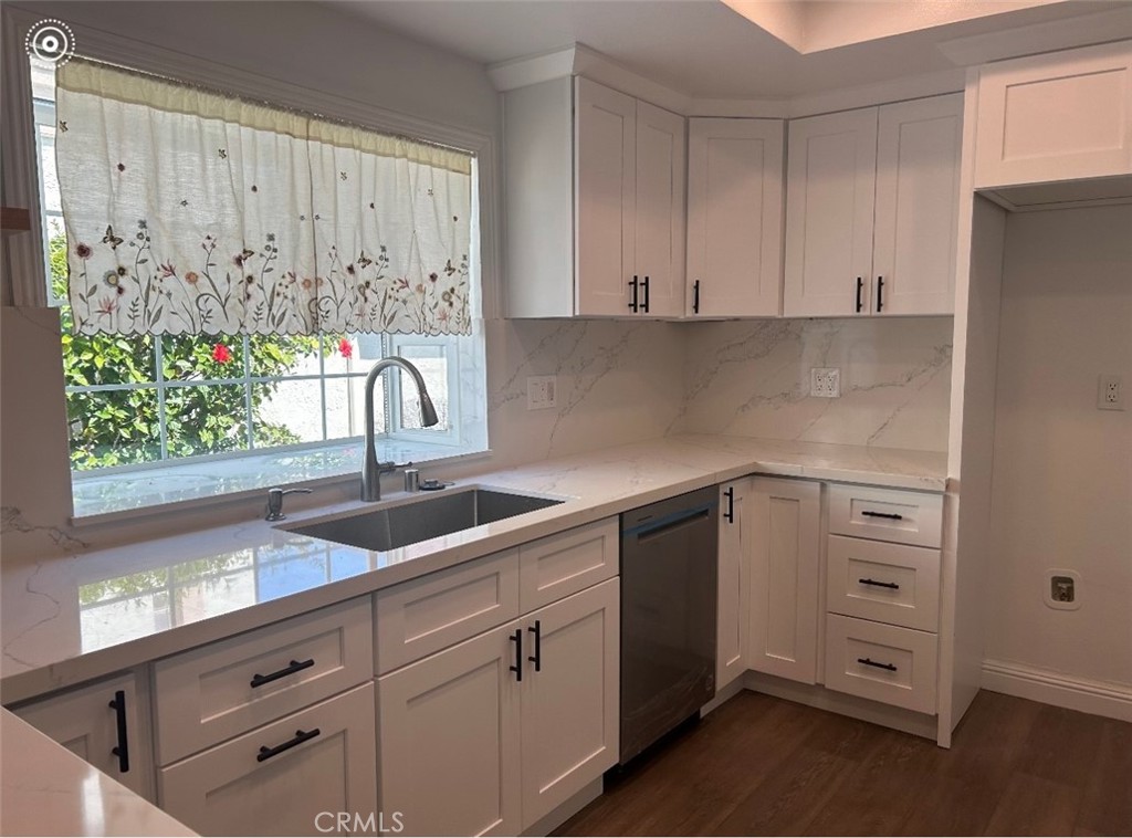 23 Willowbrook Irvine, CA 92604 - Photo 3 of 4 a kitchen with white cabinets and sink