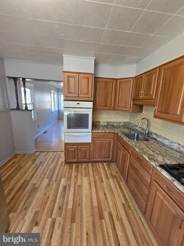 a kitchen with a sink and a stove top oven