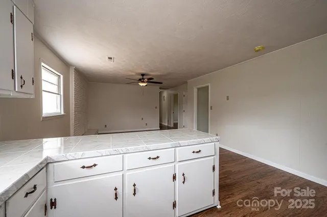 a view white cabinets and wooden floor