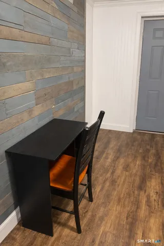 a view of house with yard and trees in the background