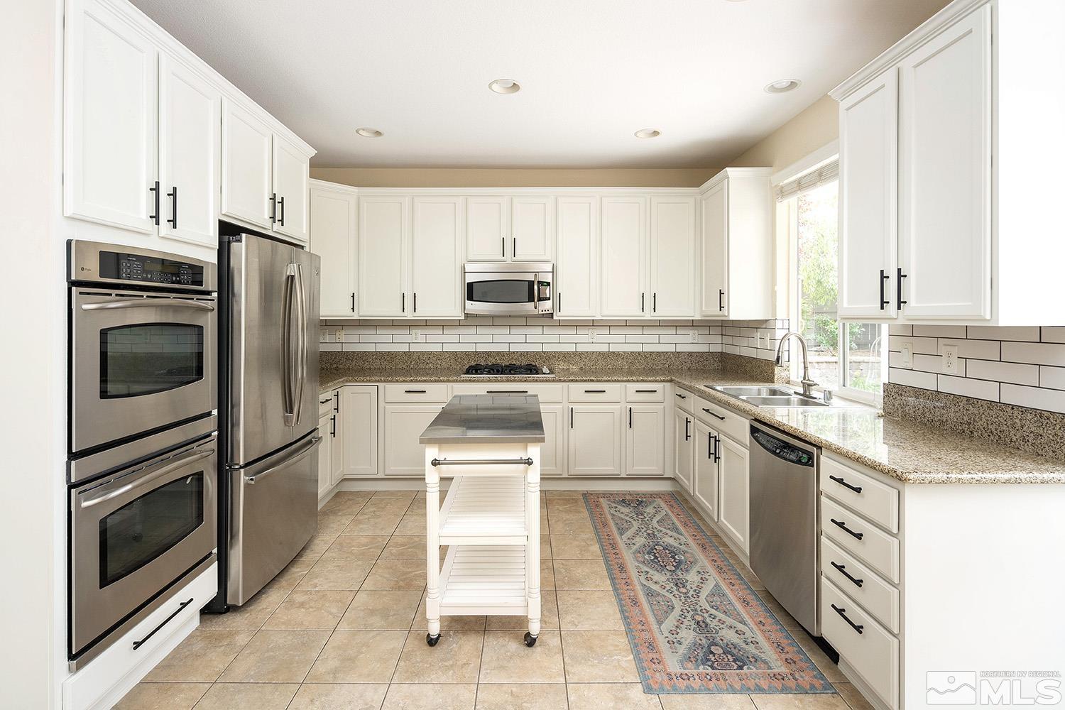 570 Alydar Court Reno, NV 89521 - Photo 9 of 40 a kitchen with cabinets stainless steel appliances and a window