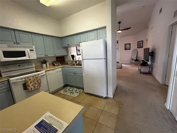 a kitchen with a refrigerator a stove a sink and a counter top space