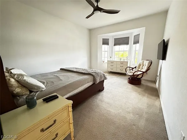 a bedroom with bed and window