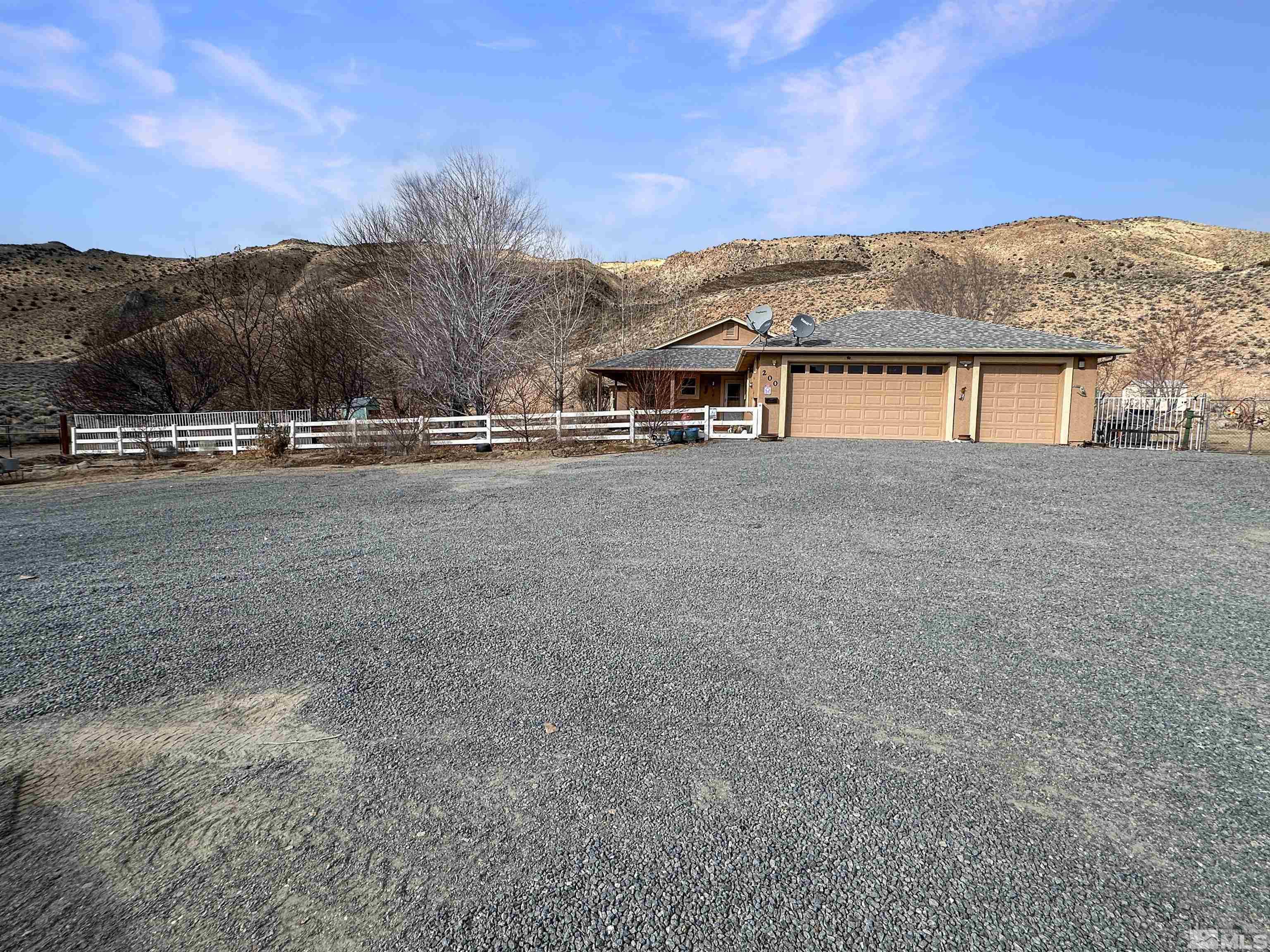 200 Descanso Lane Sparks, NV 89441 - Photo 2 of 28 a view of a house with a yard and large tree
