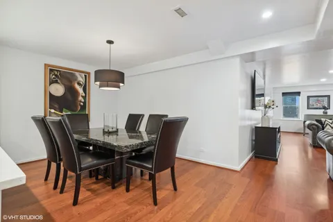 a view of a dining room with furniture and wooden floor