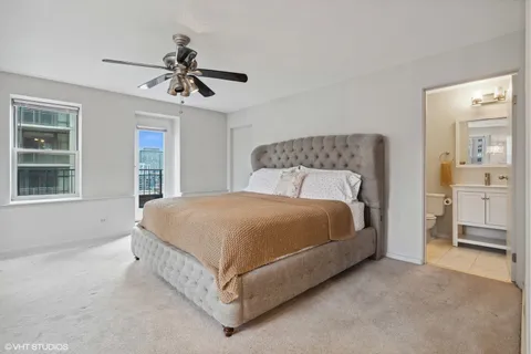 a spacious bedroom with a bed and a cabinets