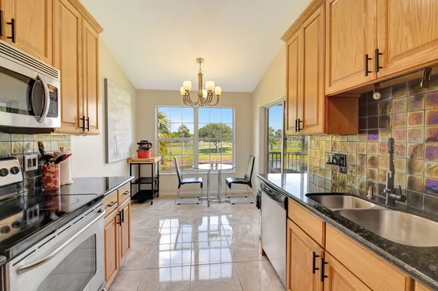 a view of a dining room with furniture wooden floor and a chandelier