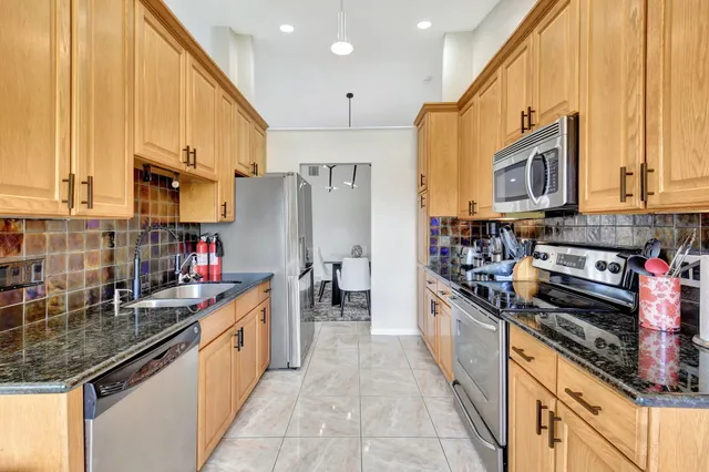 a living room with furniture and a dining table