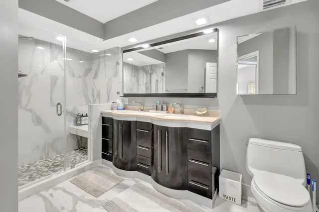 a bathroom with a sink double vanity and shower