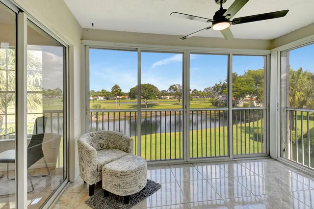 a view of a porch with a floor to ceiling window and wooden floor