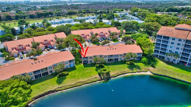 an aerial view of residential houses with outdoor space and river view
