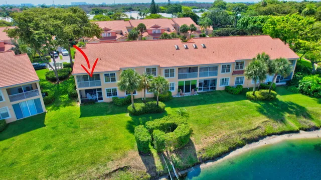 an aerial view of a house with a lake view
