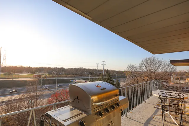 a view of a roof deck with couches and wooden floor