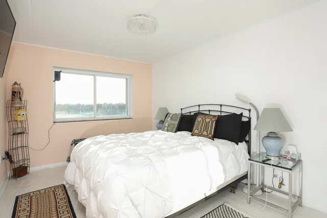 a bedroom with a bed and a mirror