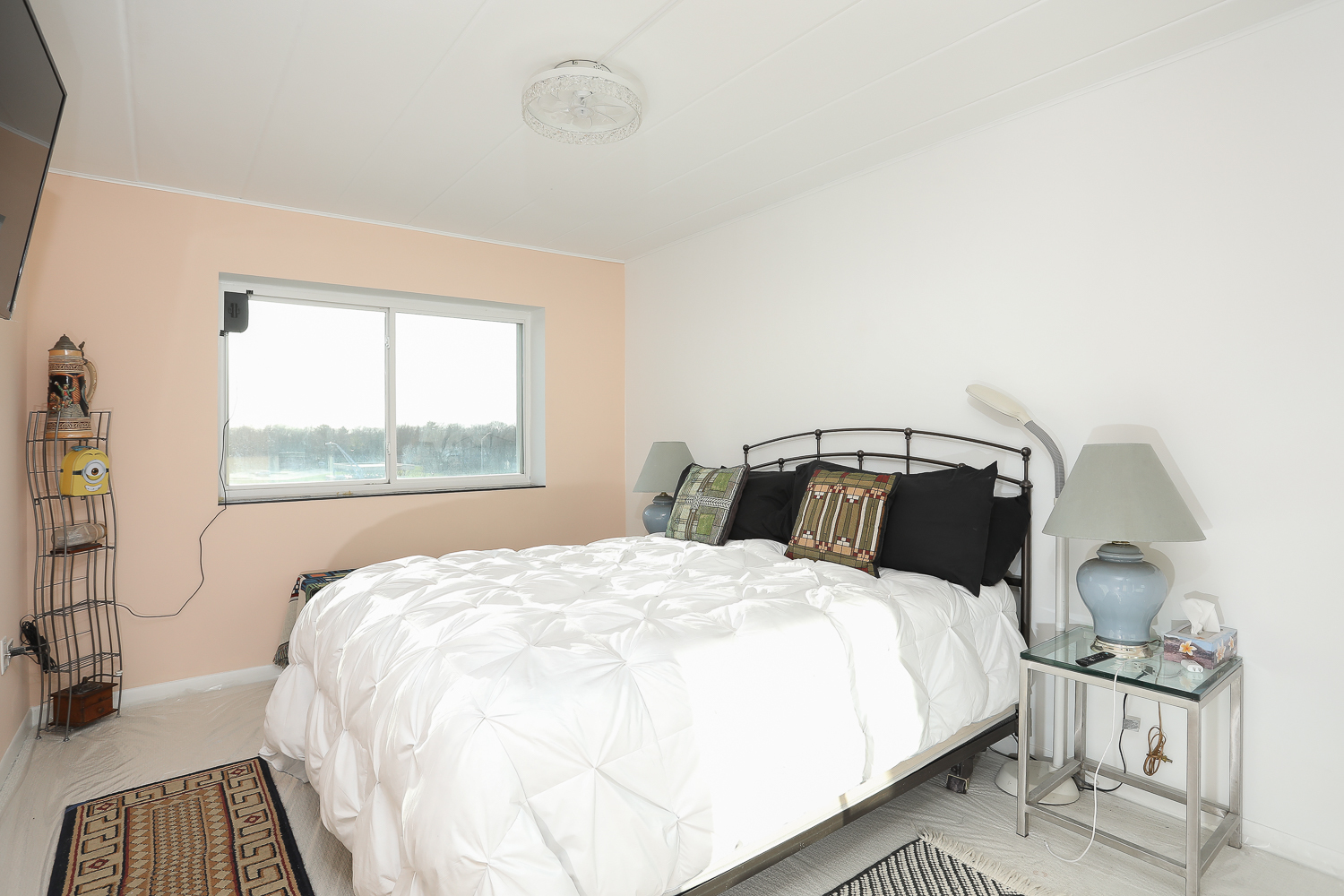 2900 Maple Avenue, Unit 19E Downers Grove, IL 60515 - Photo 17 of 32 a bedroom with a bed and wooden floor