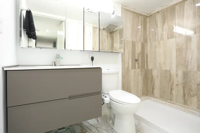 a bathroom with a shower and a glass door