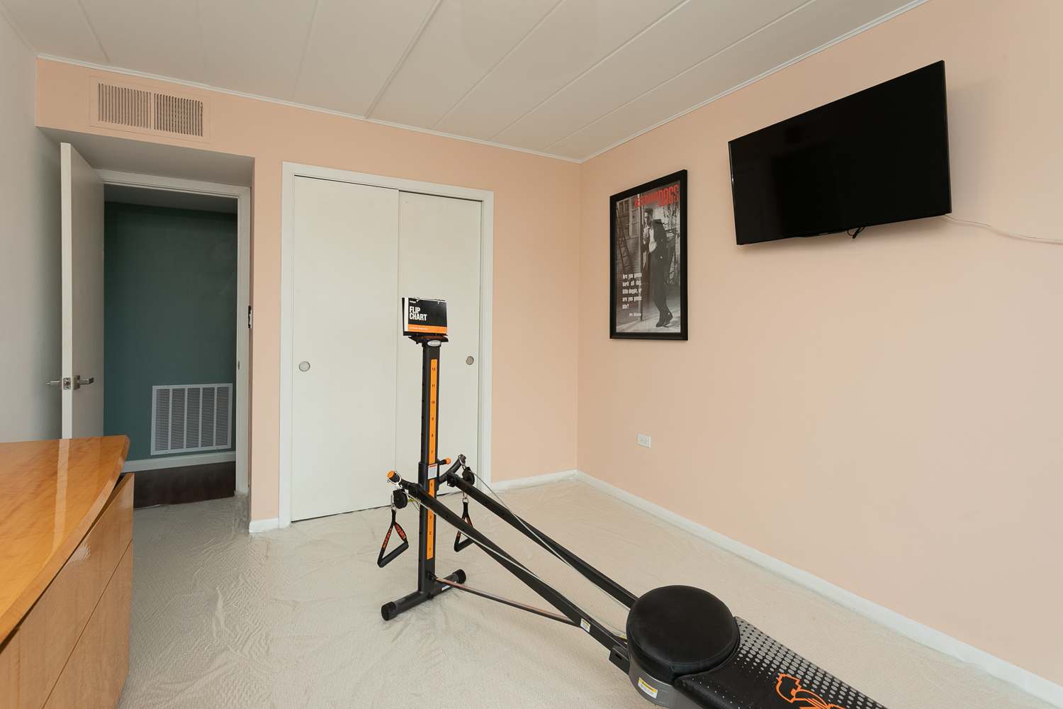 2900 Maple Avenue, Unit 19E Downers Grove, IL 60515 - Photo 23 of 32 a room with gym equipment and a flat screen tv