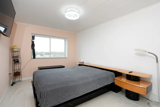 a bed room with a bed and a chair