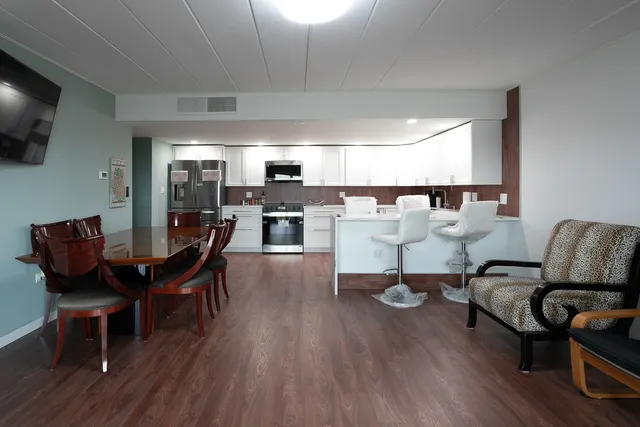 a view of a dining room with furniture and wooden floor