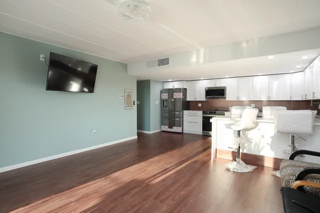 a view of kitchen and dining room with wooden floor
