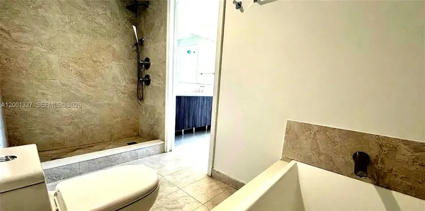 a bathroom with a bathtub and shower
