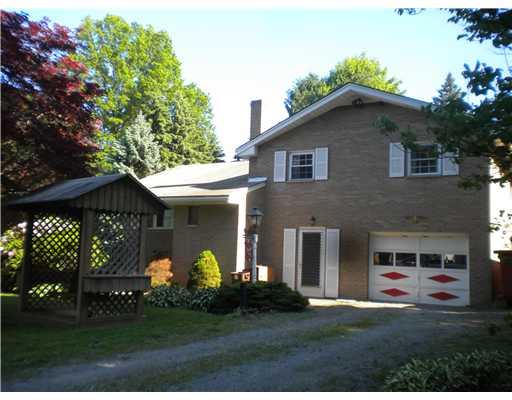 Exterior Front. Distinguished brick multi-level home on 3/4 level acre lot.....Partially fenced rear yard. Double shed. Covered porch & covered swing.  Charm & character.....