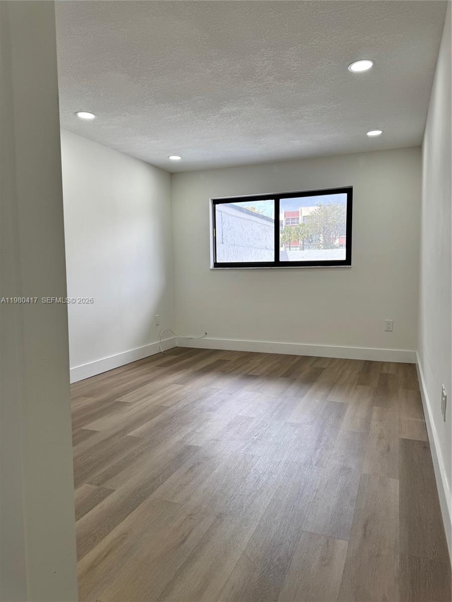 9425 Southwest 4th Lane, Unit 9425 Miami, FL 33174 - Photo 11 of 14 a view of a room with wooden floor and window