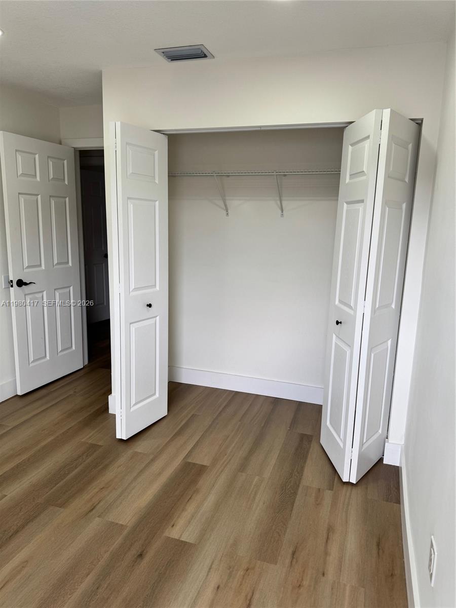 9425 Southwest 4th Lane, Unit 9425 Miami, FL 33174 - Photo 14 of 14 an empty room with wooden floor and closet area