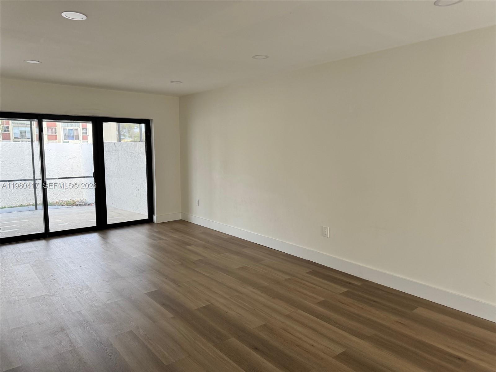 9425 Southwest 4th Lane, Unit 9425 Miami, FL 33174 - Photo 6 of 14 a view of a room with wooden floor and window