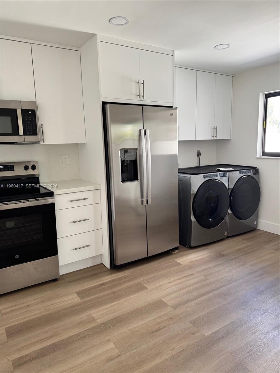 9425 Southwest 4th Lane, Unit 9425 Miami, FL 33174 - Photo 8 of 14 a kitchen with stainless steel appliances granite countertop a refrigerator and a stove top oven