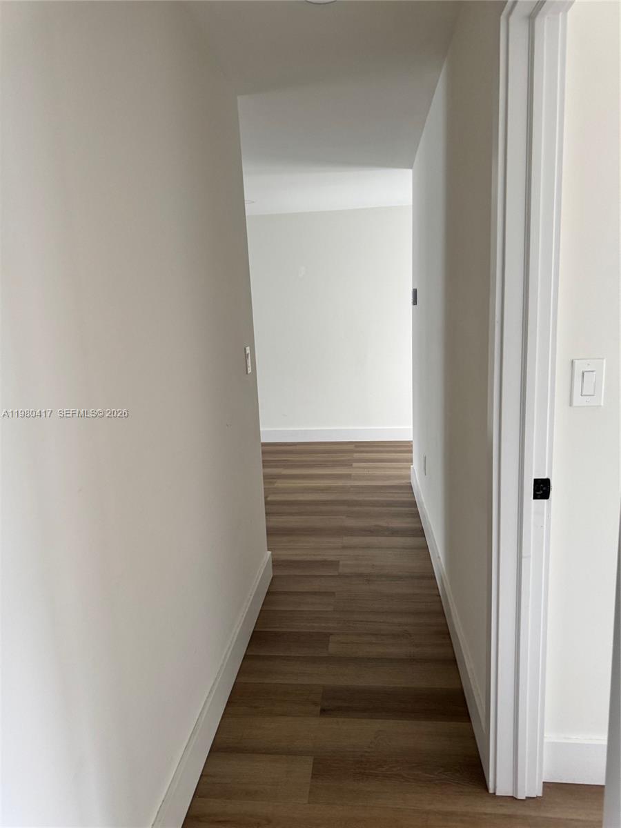9425 Southwest 4th Lane, Unit 9425 Miami, FL 33174 - Photo 9 of 14 a view of a hallway with wooden floor and entryway