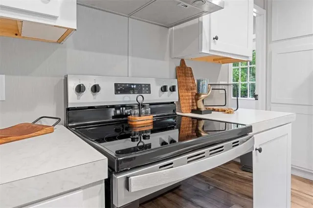 a kitchen with kitchen island a stove a sink and a counter space
