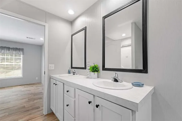 a bathroom with a sink double vanity and a mirror