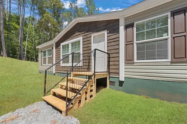 a backyard of a house with table and chairs