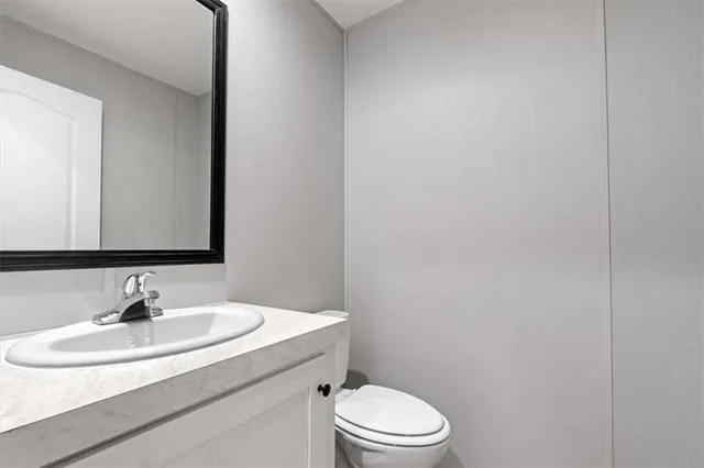 a bathroom with a sink a toilet and mirror