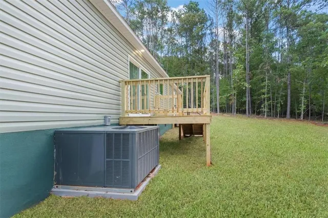 a view of backyard with a deck and garden